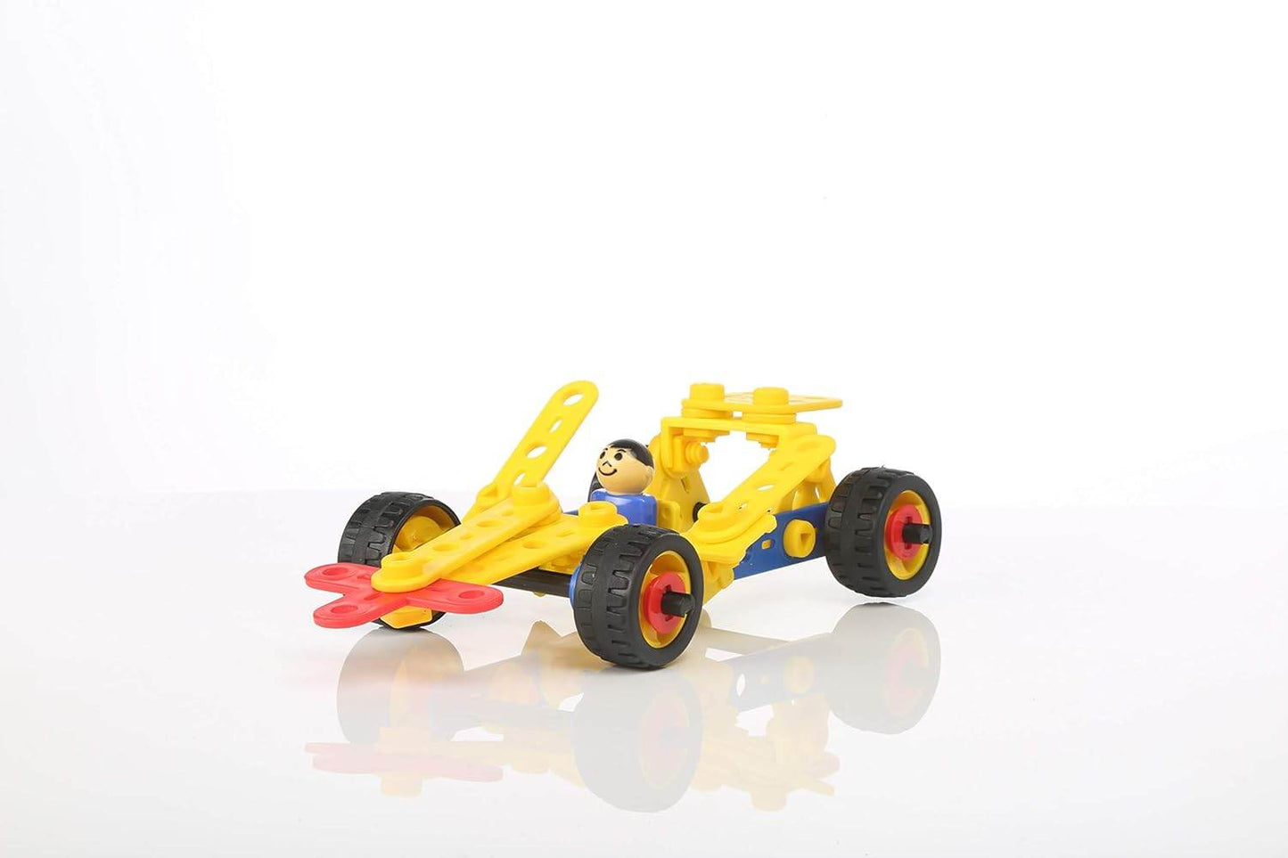 Yellow plastic construction car toy with a driver figure and large black wheels on a white background