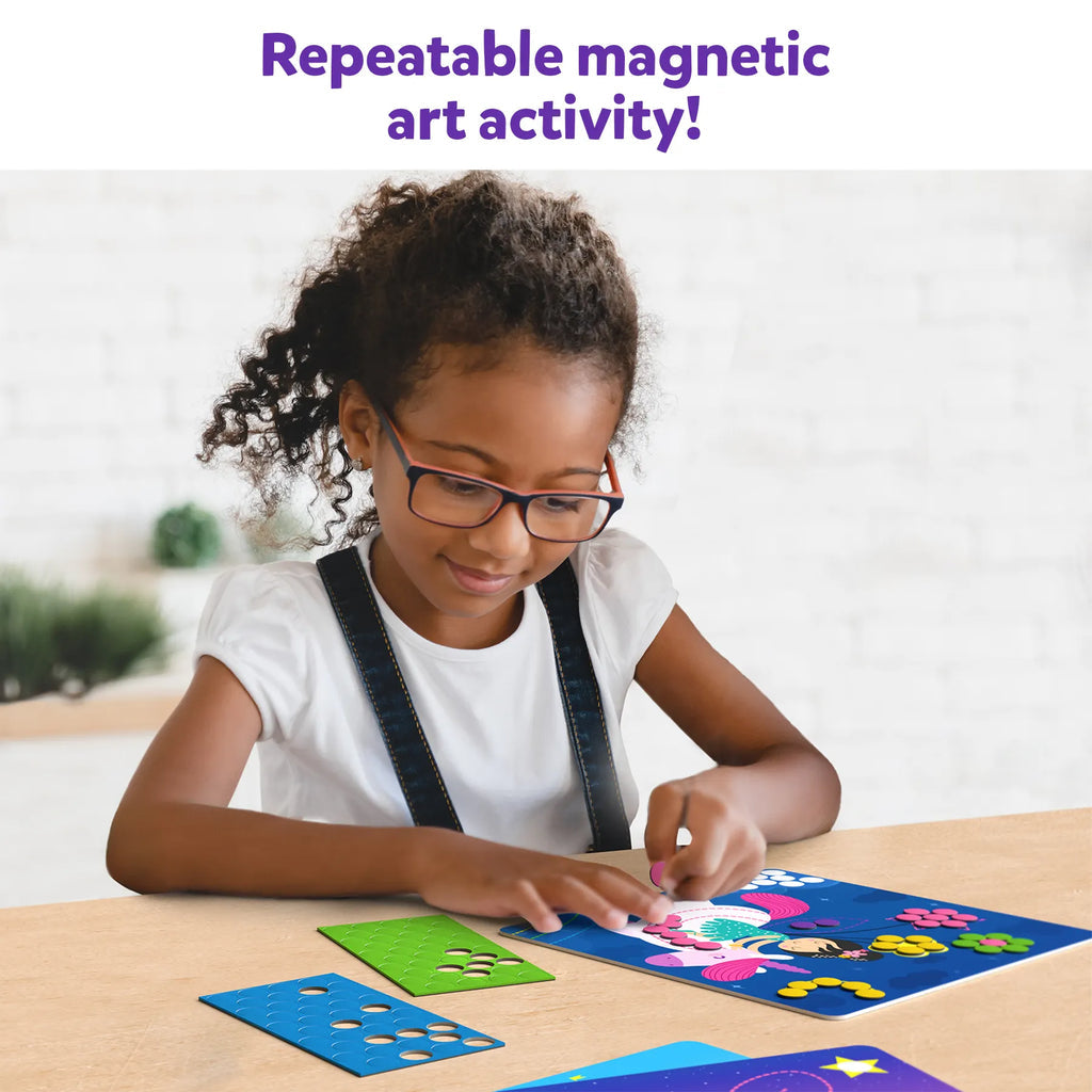 Girl playing with Skillmatics Dot it princess magnet activity set creating magnetic art designs