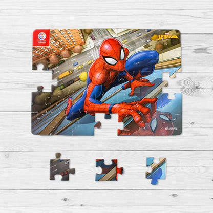 Spiderman jigsaw puzzle for kids featuring colorful Spiderman swinging in cityscape with puzzle pieces on wooden surface
