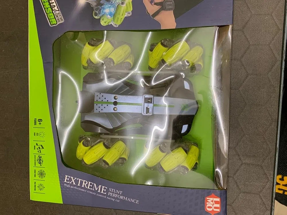 Remote control car with remote in black and green design for ages 6 and up with stunt capabilities