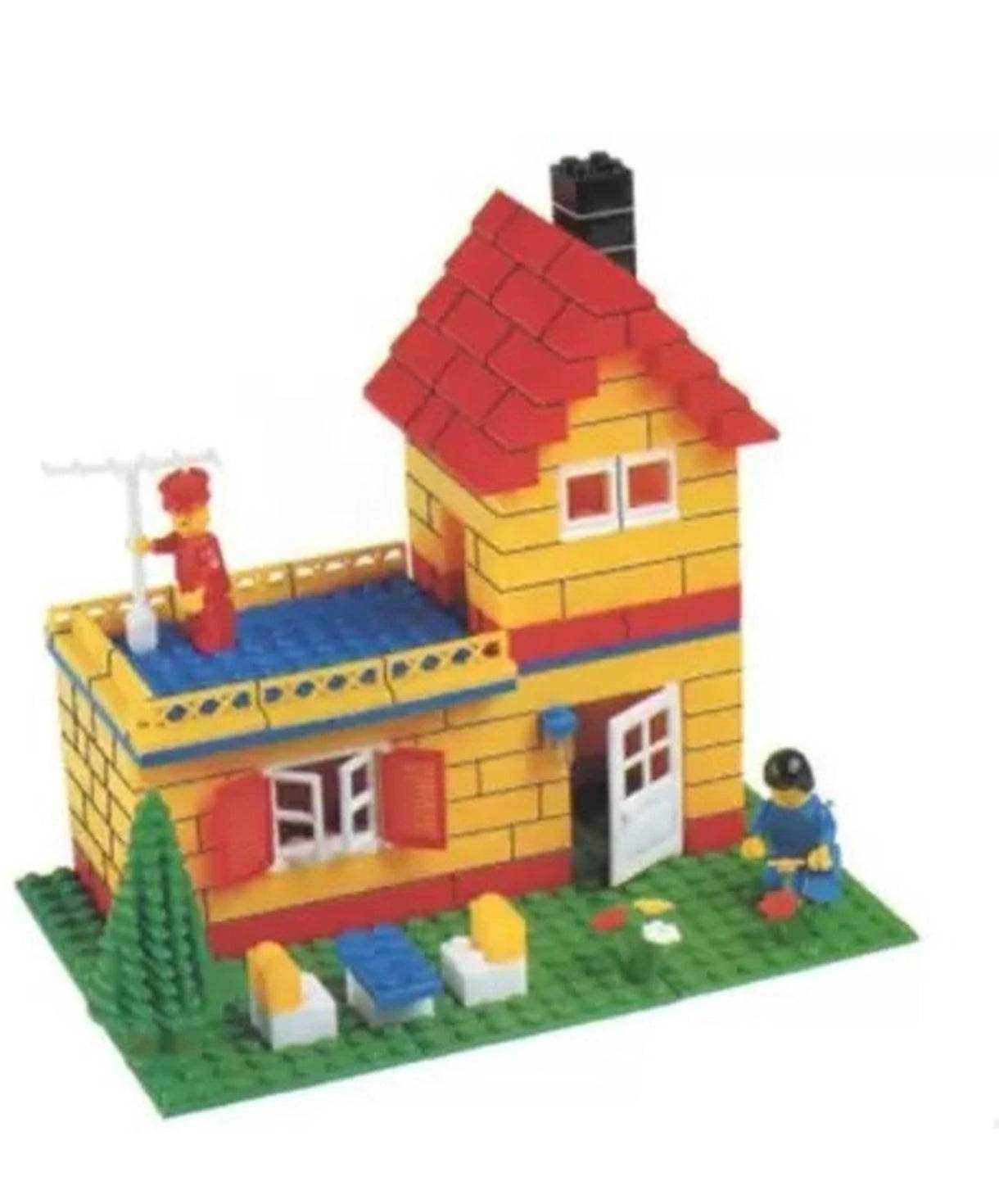 Educational construction toy set featuring a yellow and red brick house with mini figures and outdoor furniture