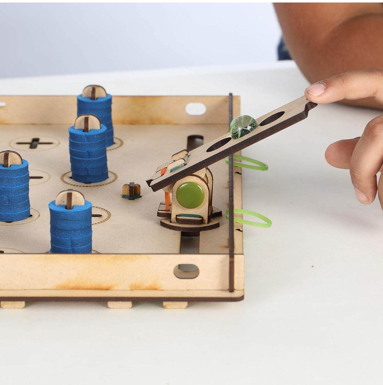 Smartivity Chess Attack construction kit wooden game pieces with a child playing on a white surface