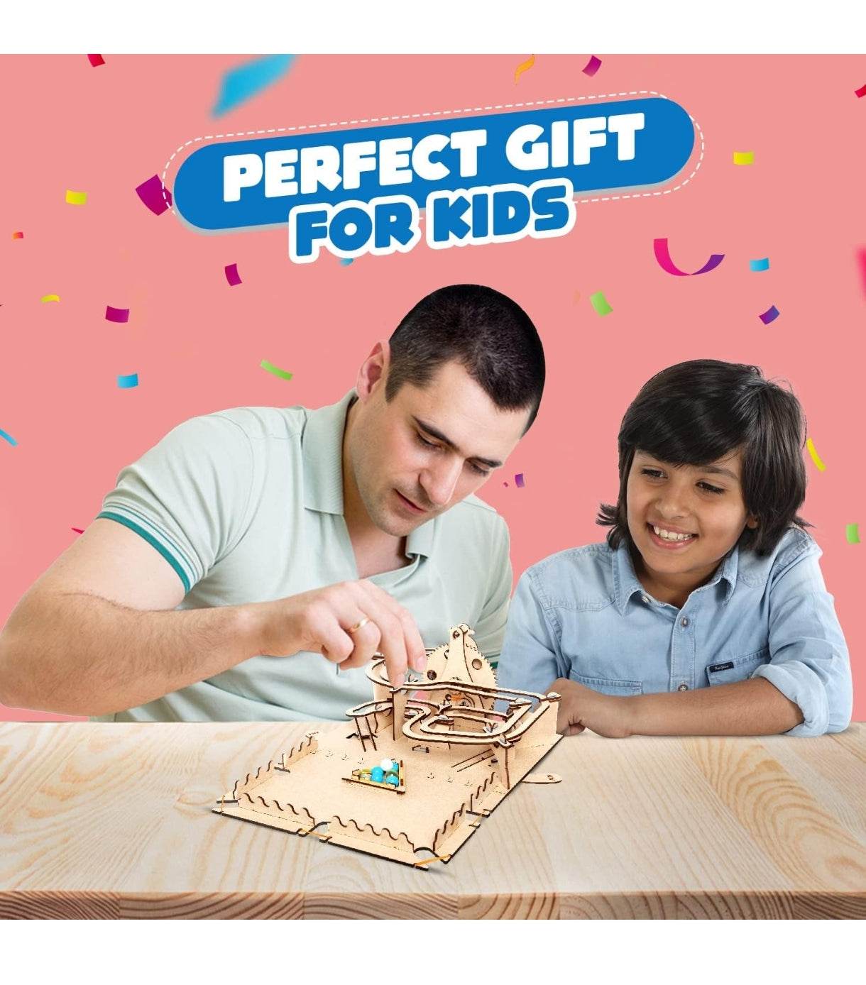 Father and son playing with STEM marble run kit for kids on wooden table with pink background