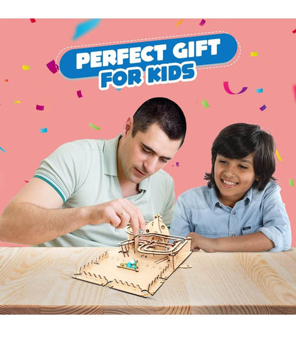 Father and son playing with STEM marble run kit for kids on wooden table with pink background