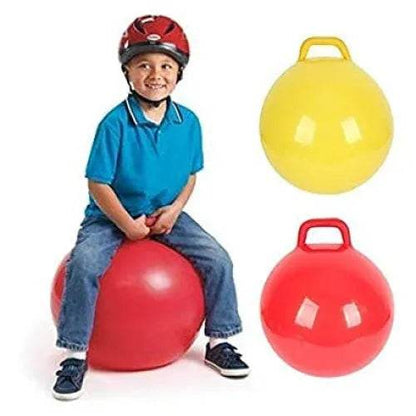 Child sitting and bouncing on a red space hopper ball for kids with handle, yellow and red balls shown