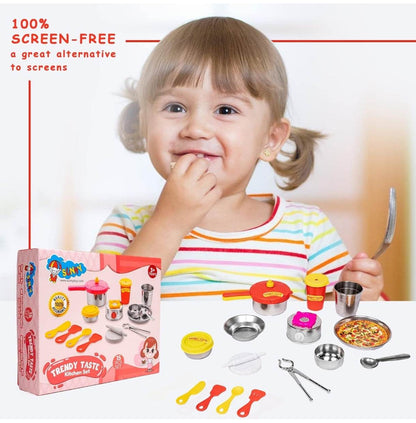 Child playing with 15 piece trendy kitchen playset including pots, utensils, and toy food with packaging