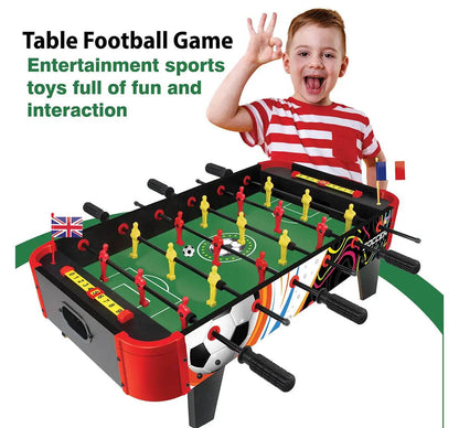 Tabletop foosball game for kids with red and yellow players and black handles, featuring a green field and a happy child