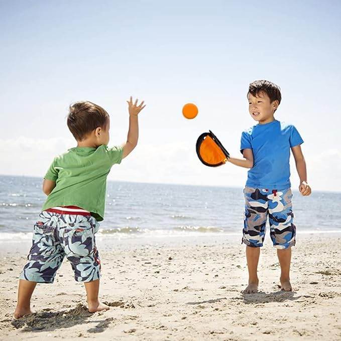 Catching game with orange throwing ball for kids aged 3-7 years at the beach