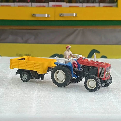 Red and blue tractor toy with trolley featuring a farmer figurine driving the vehicle