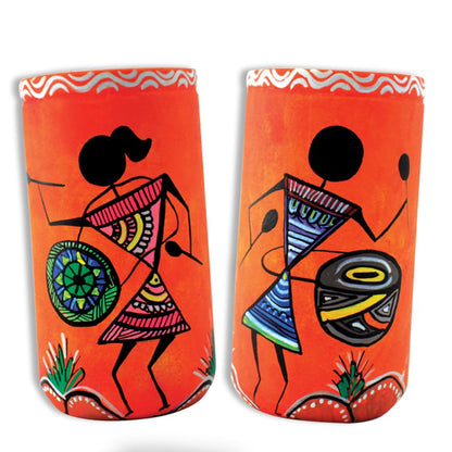Colorful orange Warli painting art on decorative mugs showcasing traditional tribal figures