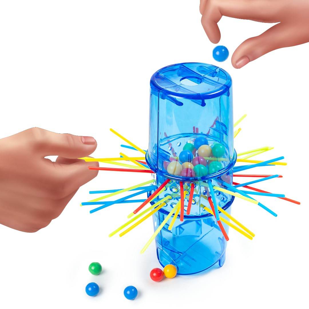 Toysbox Neo Ouch skill game with blue plastic tower, colorful sticks, and marbles held by two hands