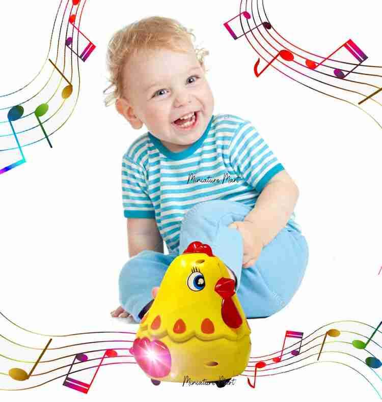 Happy toddler playing with Toyzone hen bump and go toy musical yellow chicken toy